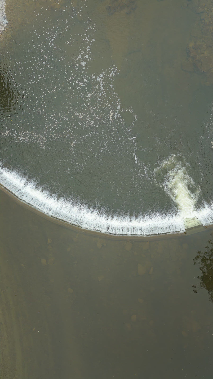 Curved River Weir with Flowing Water - Pullup Aerial