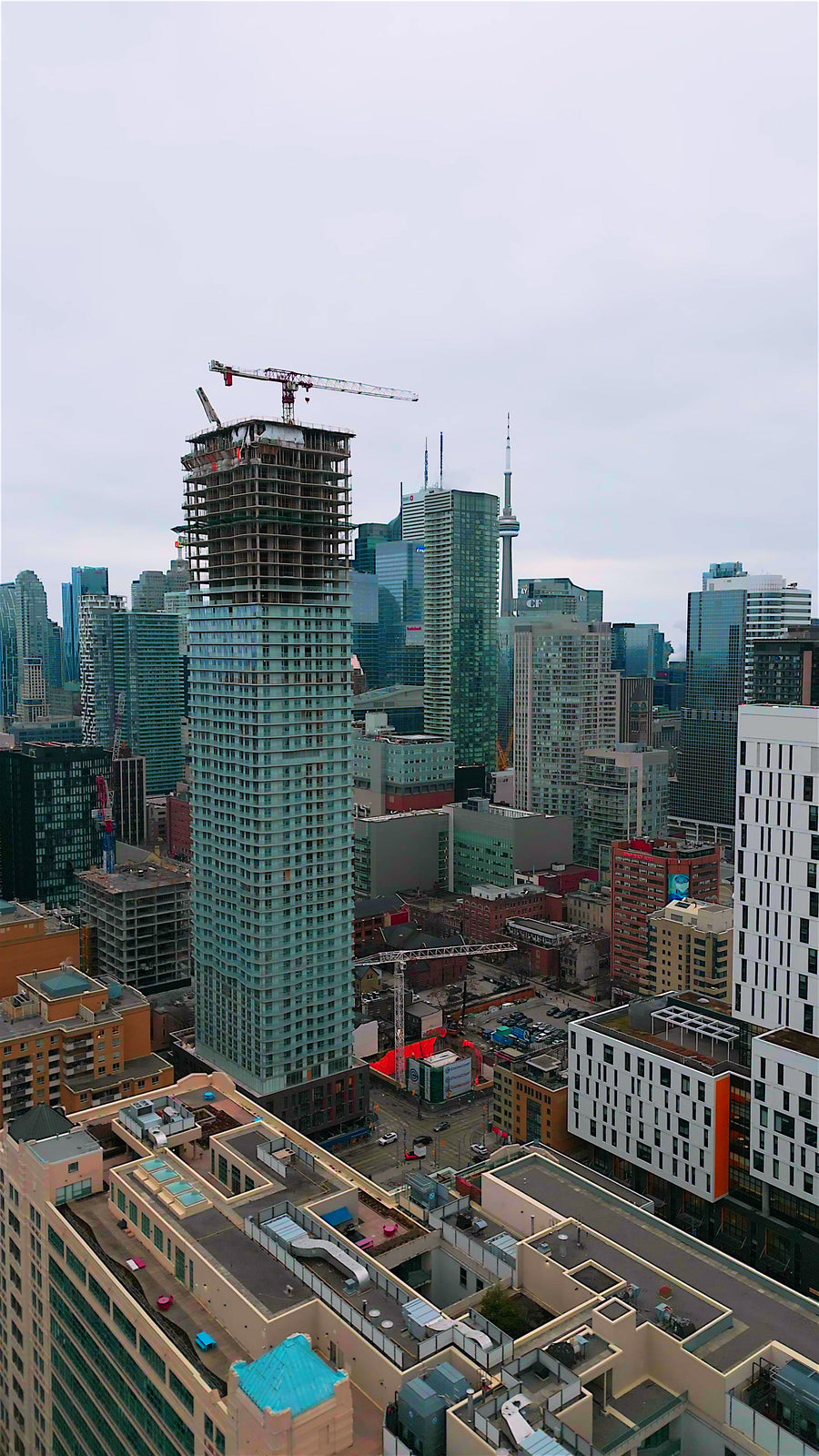 Skyscraper Construction Crane Site - Aerial Descent