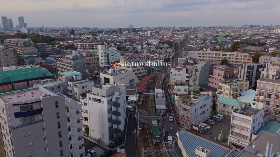 Tokyo Suburban Train Through Dense Neighborhood - Aerial