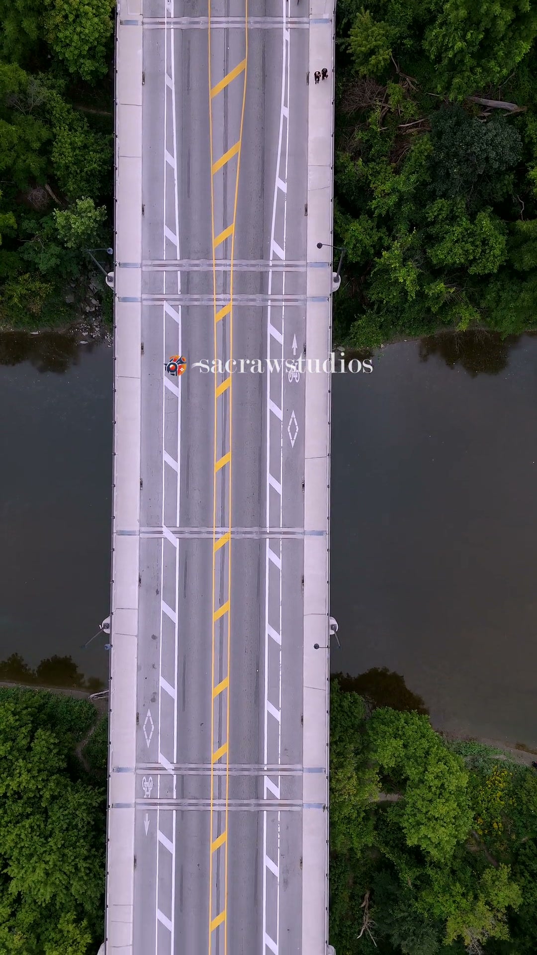 Aerial View of Asymmetric Bridge over Calm River