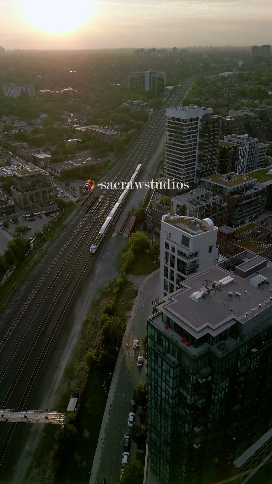 Train Tracks Through City at Sunset - Aerial Chase