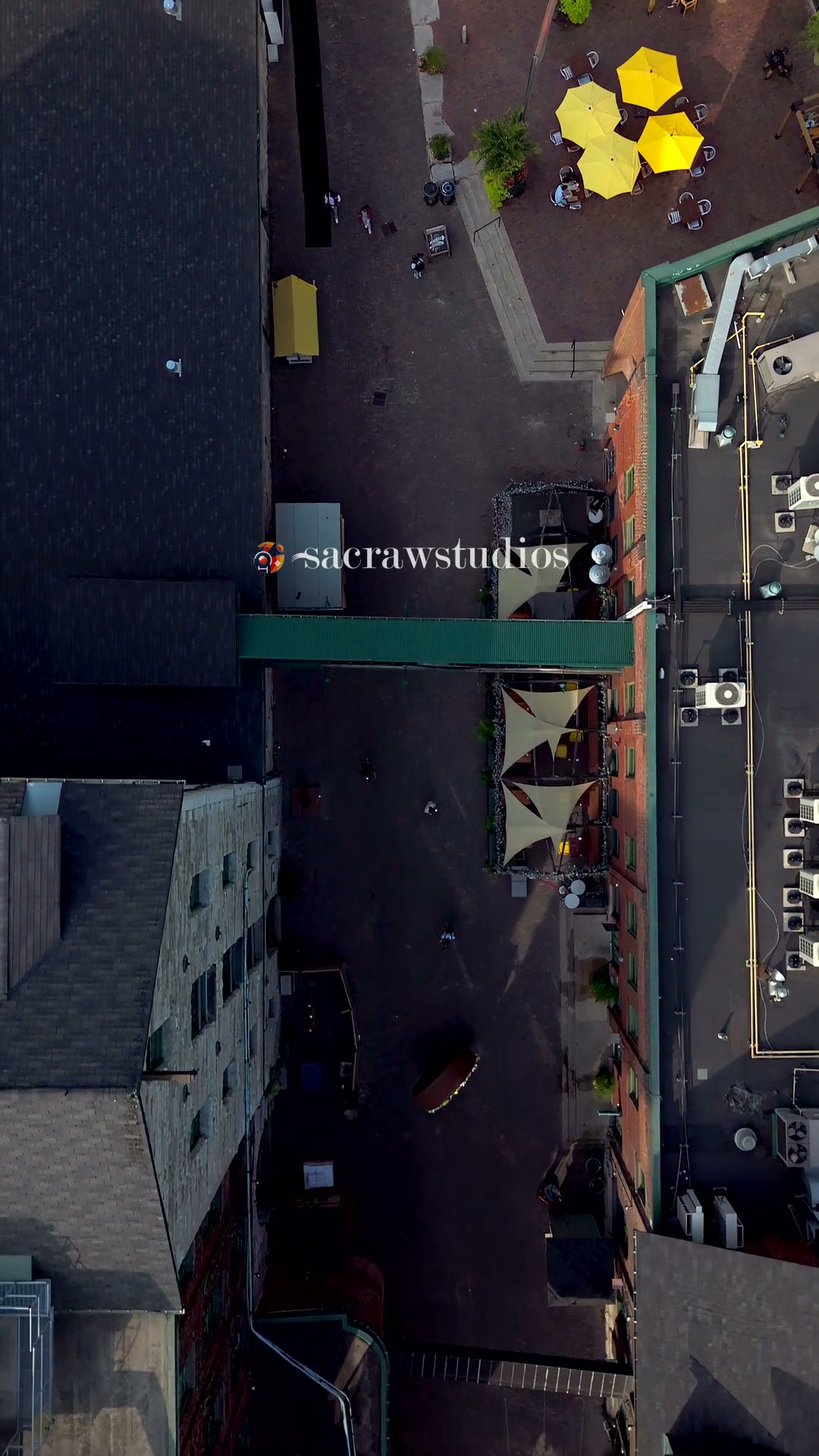 Aerial View of Urban Courtyard with Yellow Umbrellas