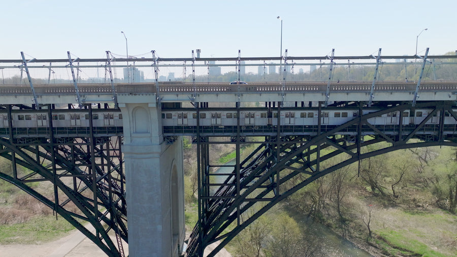 Subway Train on Steel Arch Bridge - 8K Aerial Tracking