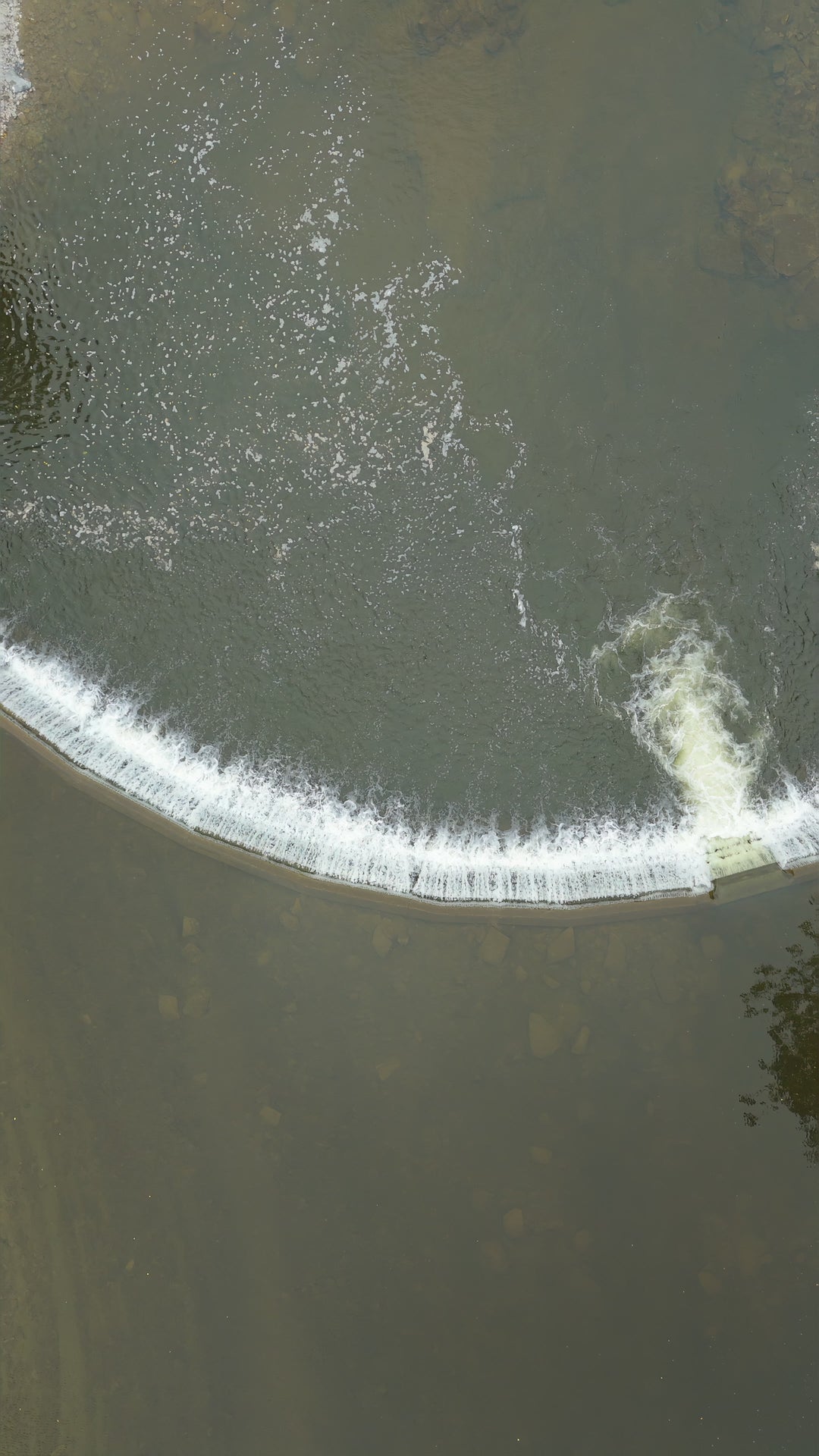 Curved River Weir with Flowing Water - Pullup Aerial — 4K stock footage