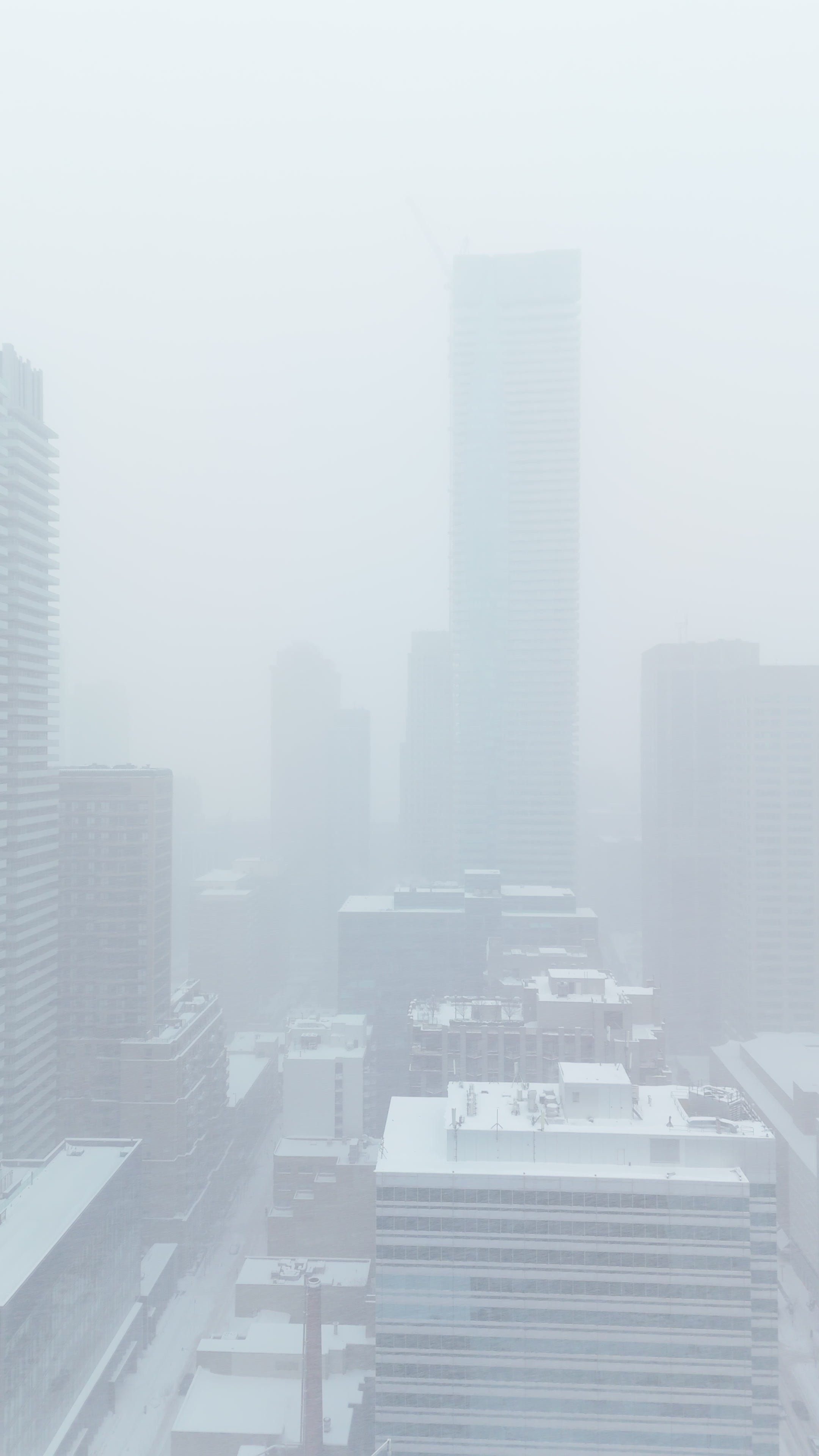 Foggy City Skyline in Winter Snow - Aerial Flythrough — 4K stock footage