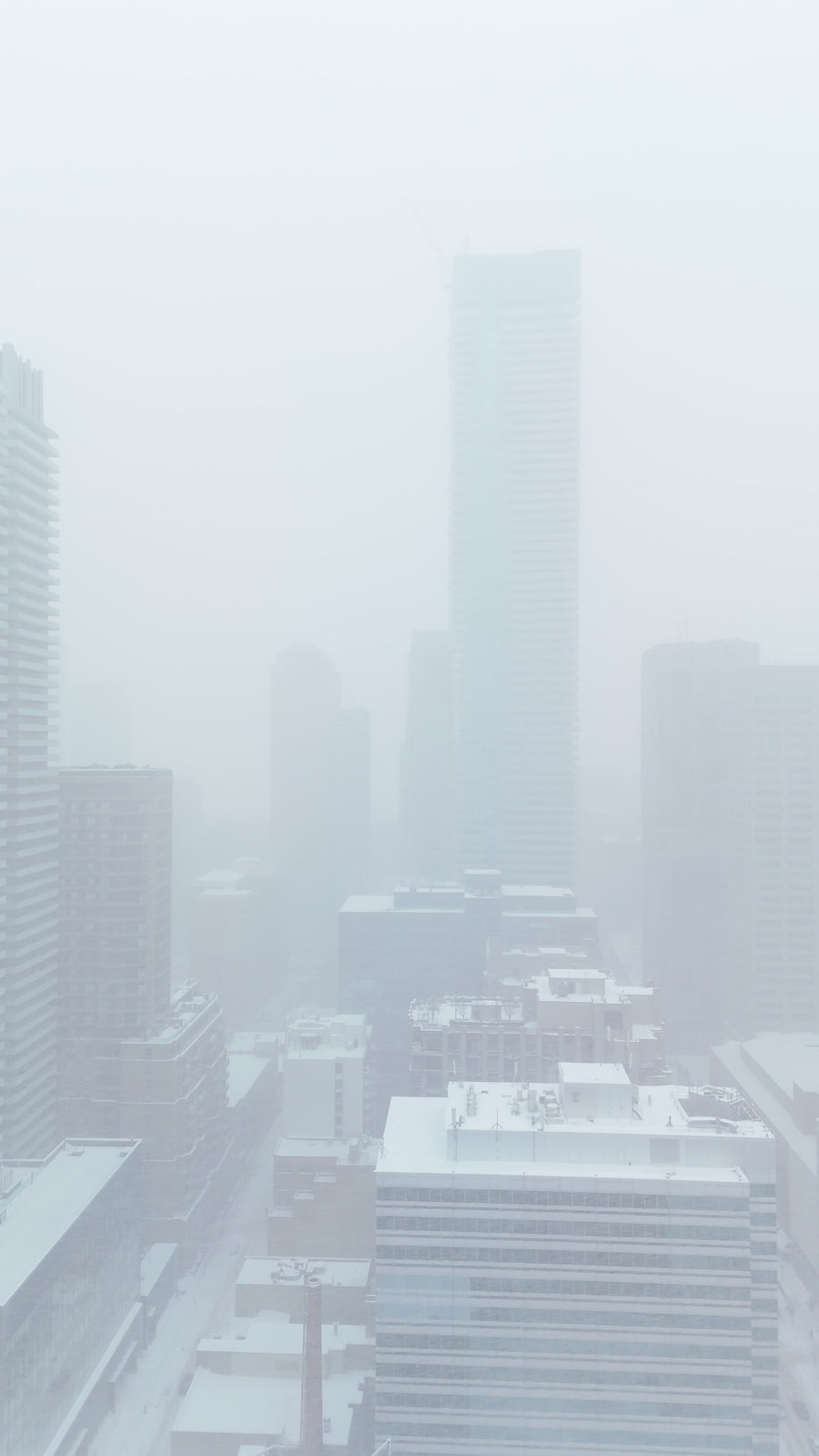 Foggy City Skyline in Winter Snow - Aerial Flythrough
