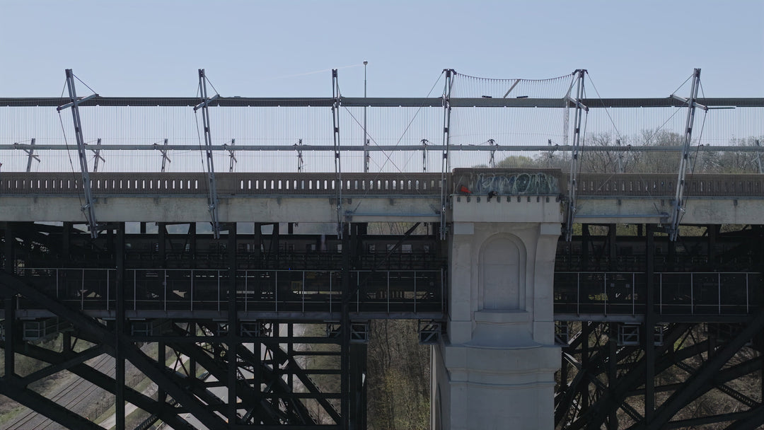 Industrial Railway Bridge with Pedestrian - Aerial Pullback — 8K stock footage