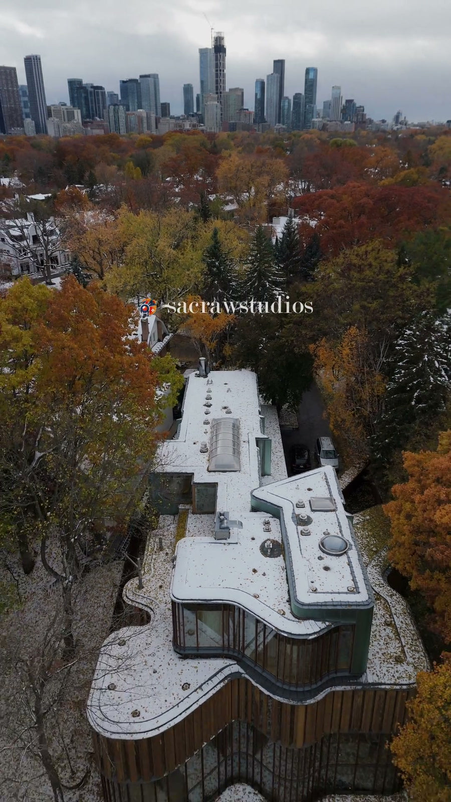 Modern Curved Wood Home in Autumn Foliage - Aerial
