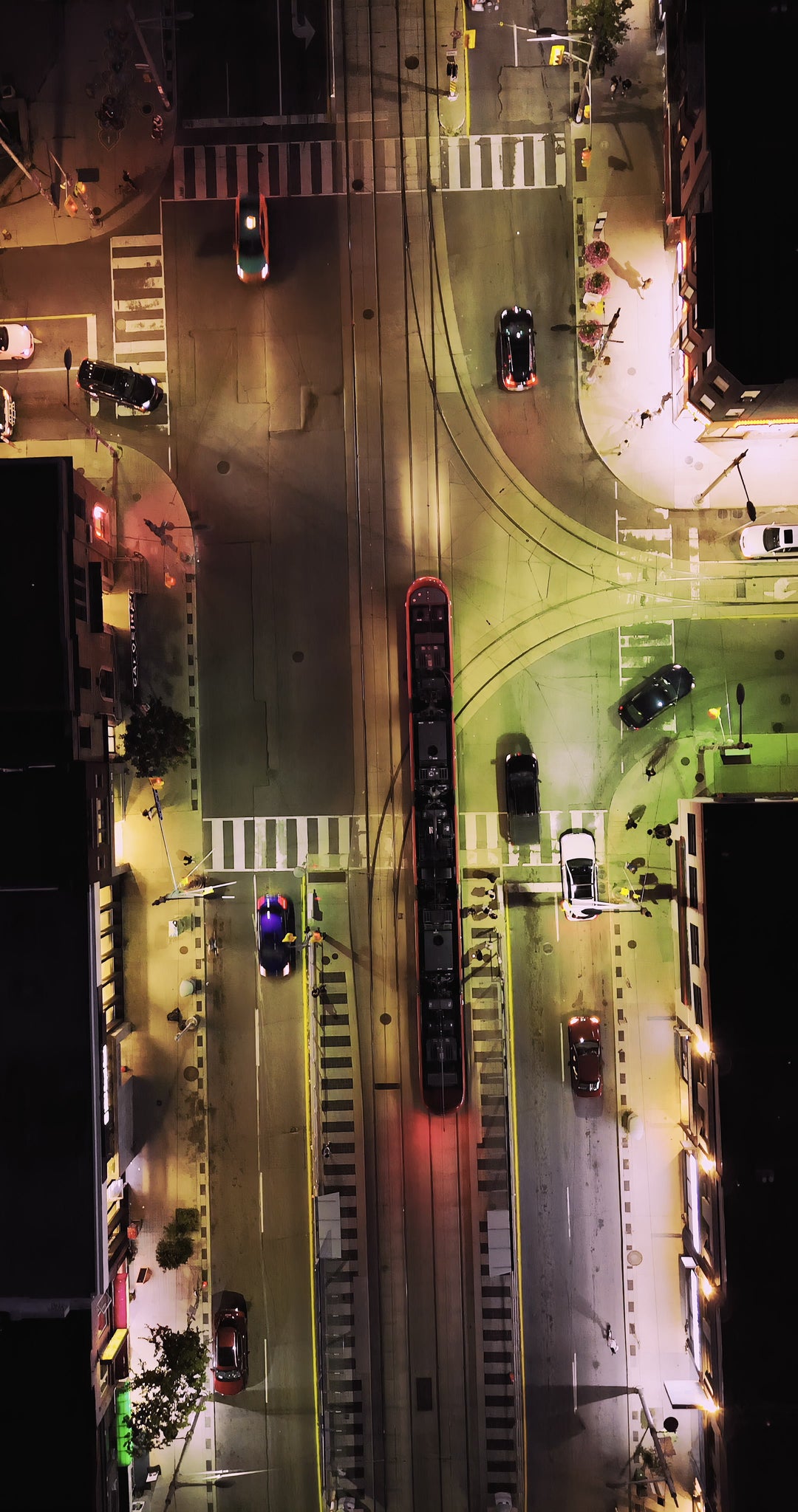 Night Tram at Urban Intersection - Aerial — 4K stock footage