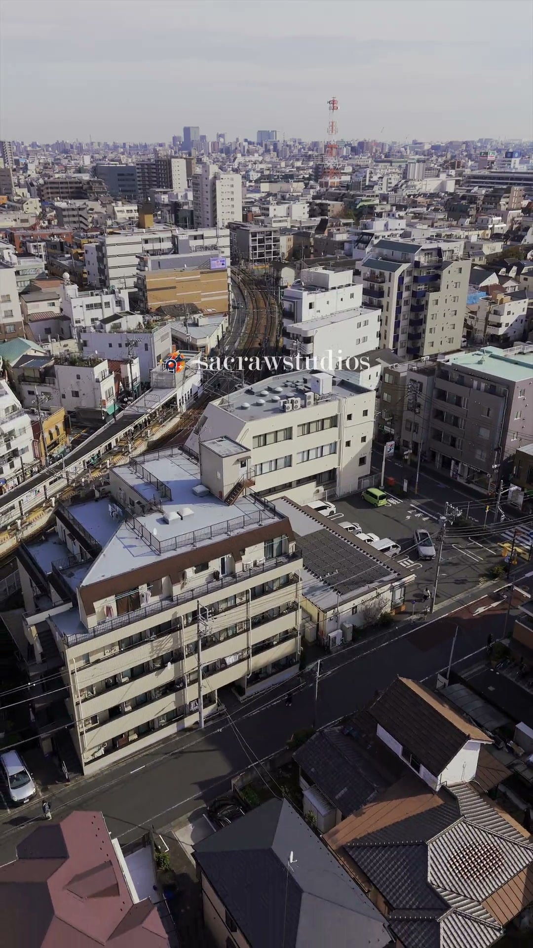 Railway Tracks Curving Through City - Aerial Drift