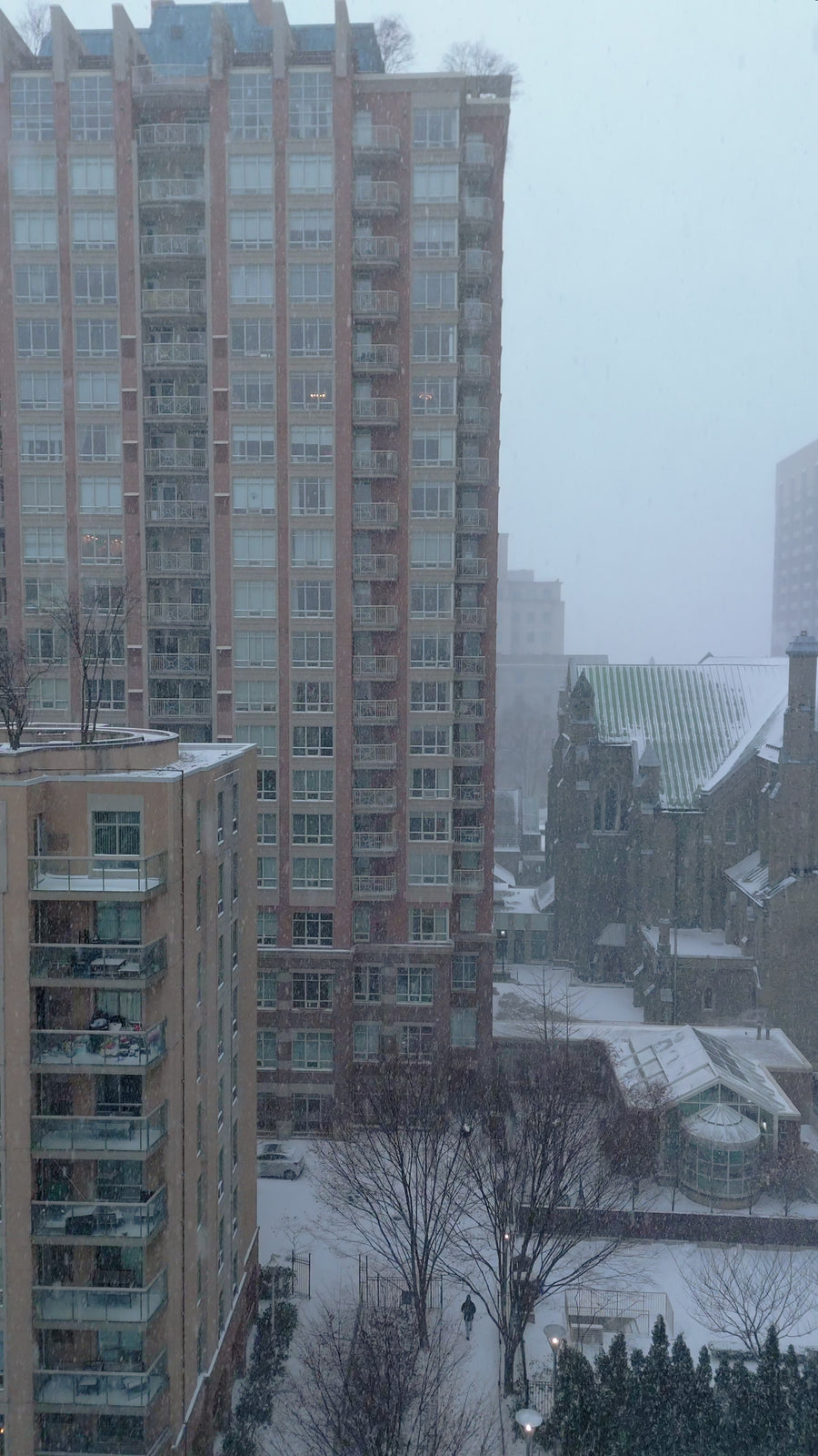 Snow-Covered Apartment Rooftops in Snowstorm - Top Down