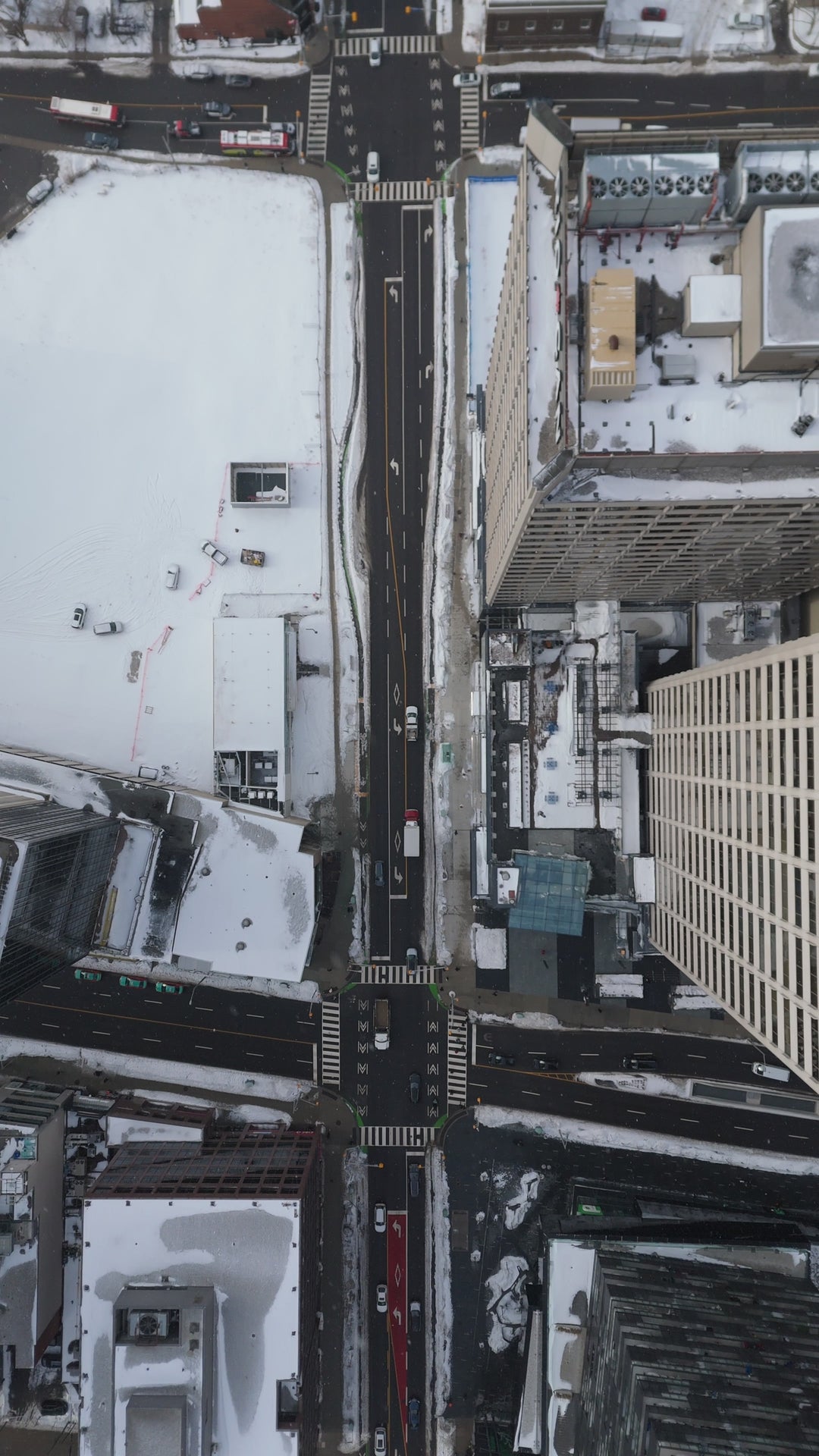 Snow - Covered City Intersection with Traffic - Top Down in winter — 4K stock footage