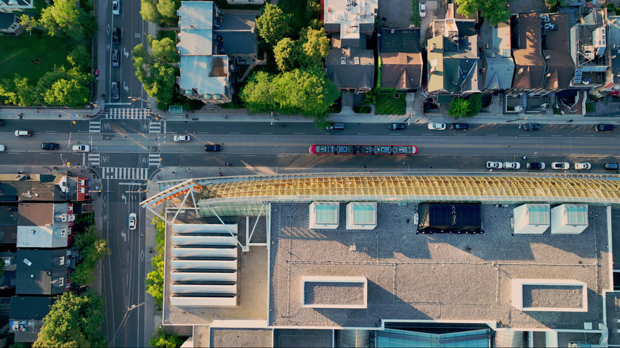 Streetcars Crossing on Sunlit Road - 4K Tracking