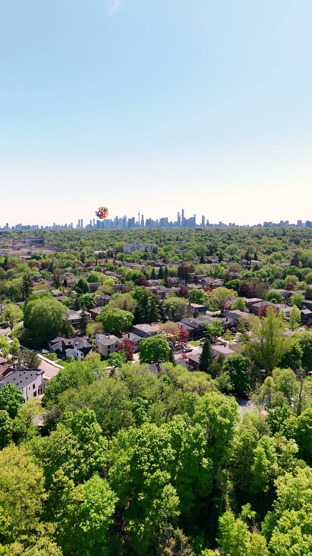 Suburban Canopy Distant City Skyline - Aerial Pan
