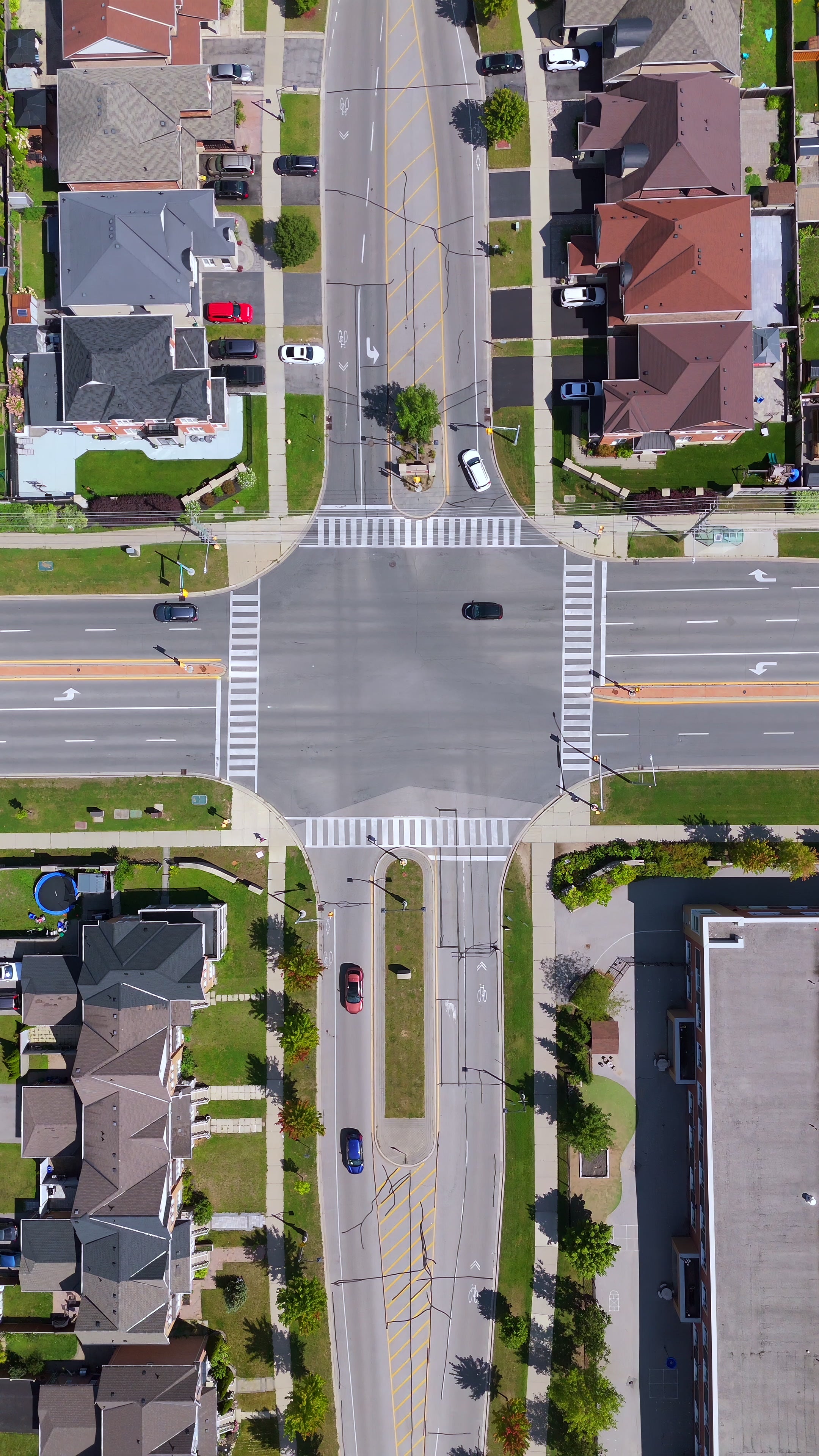 Suburban Intersection Traffic Pullback - Aerial — 4K stock footage