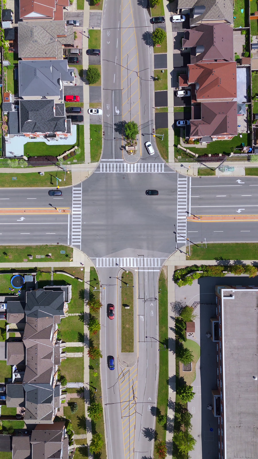 Suburban Intersection Traffic Pullback - Aerial