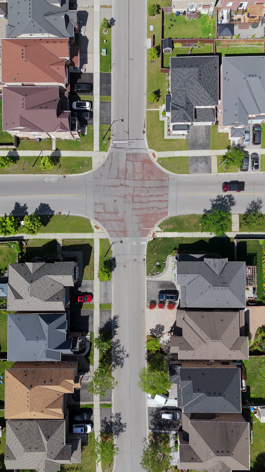 Suburban T-Intersection Flyover in Sunlight - Aerial