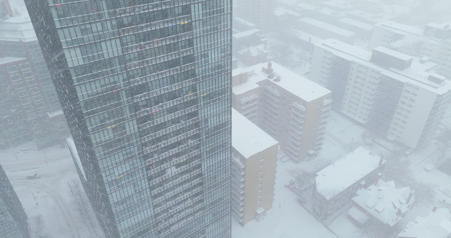 Snowy Downtown Cityscape in Blizzard - 4K Aerial