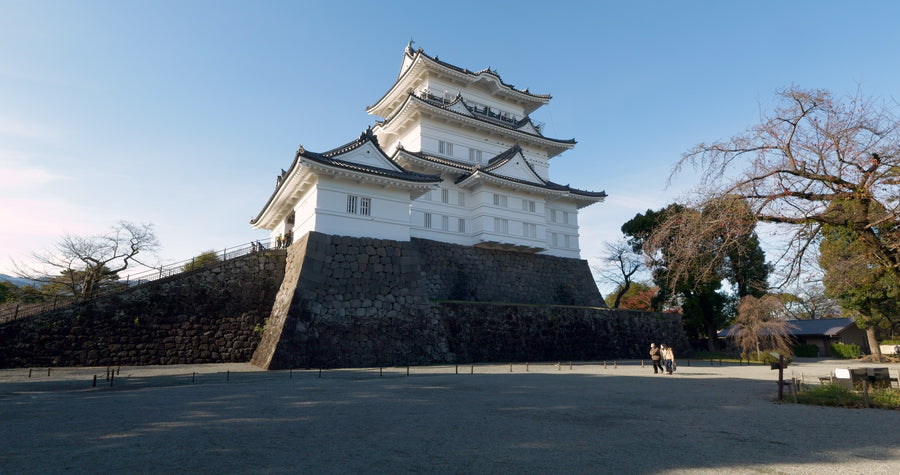 Traditional Japanese White Castle Tower on Stone Foundation