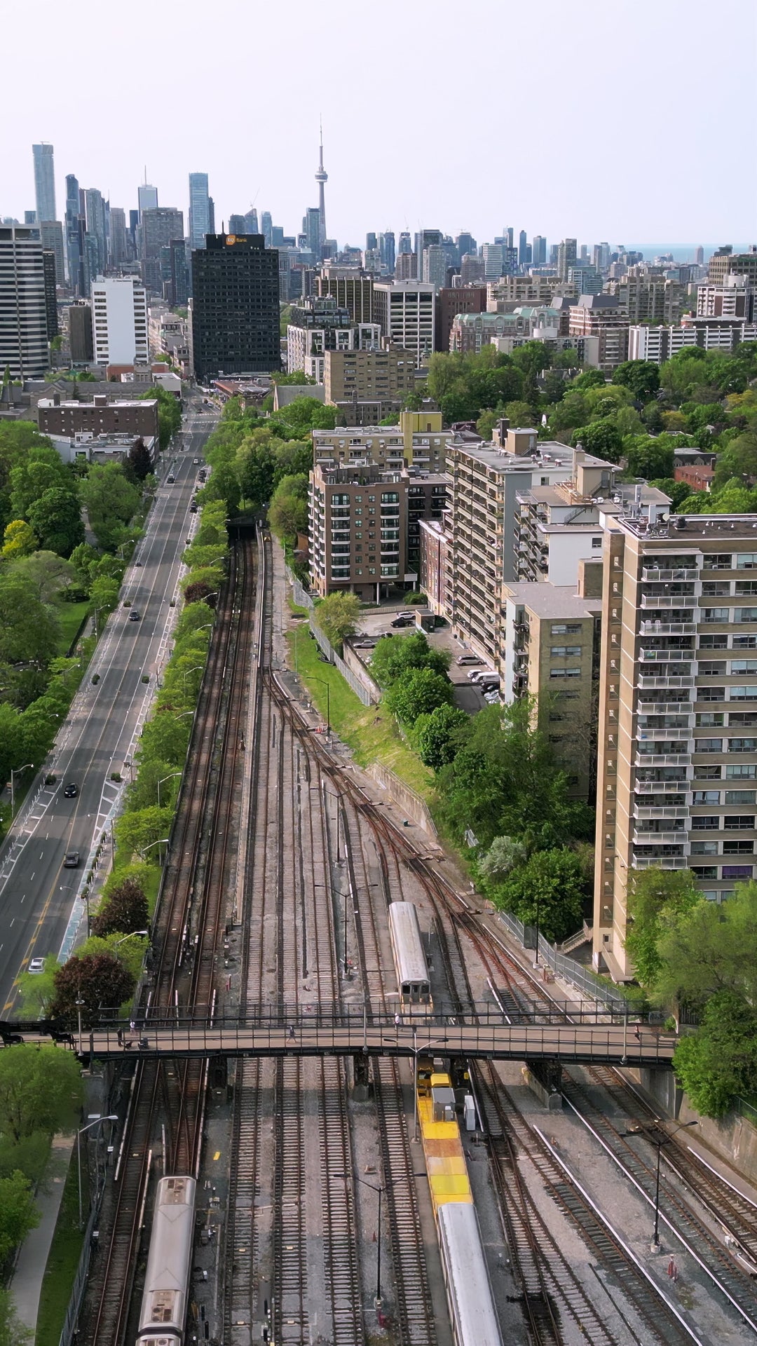 Toronto Skyline with Railway Tracks and Moving Train - Vertical Aerial