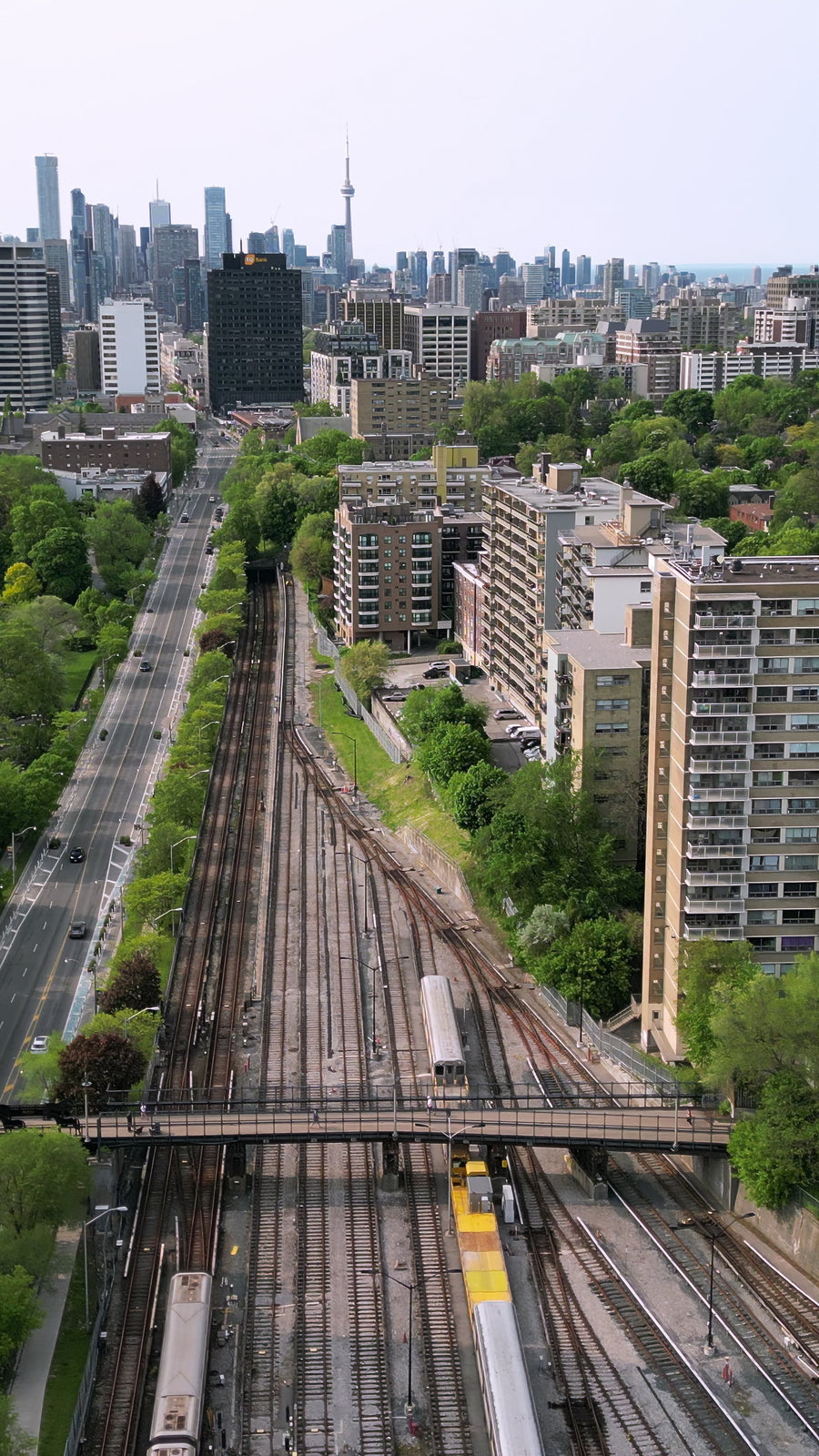 Toronto Skyline with Railway Tracks and Moving Train - Vertical Aerial