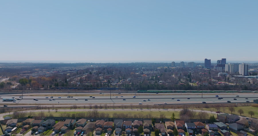 Highway Traffic with Commuter Train and Skyline - Aerial