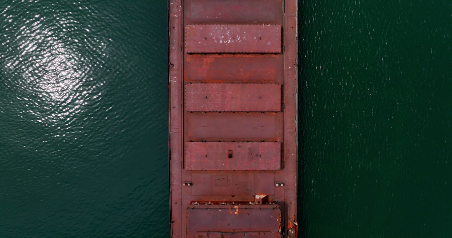 Rusty Cargo Ship on Calm Ocean - 6K Aerial