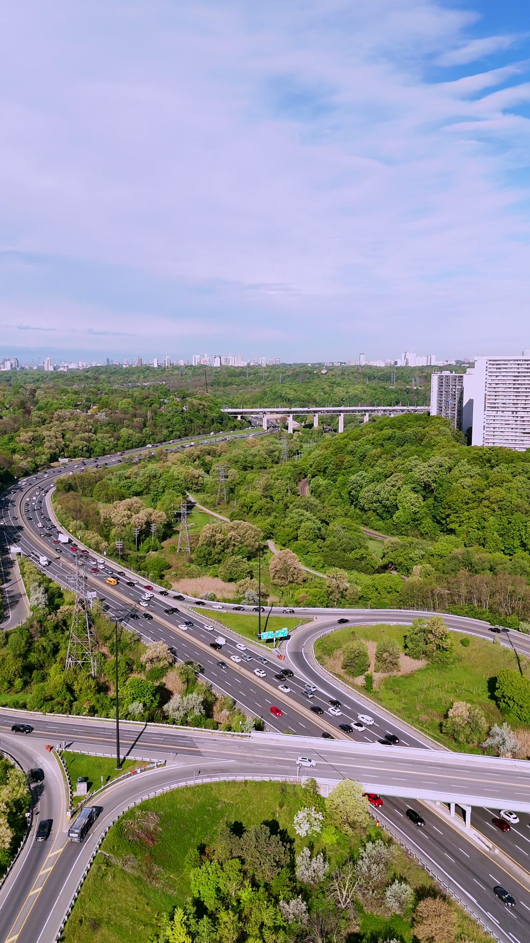 Highway Interchange with Forest and Skyline - Vertical Aerial in Toronto — 4K stock footage