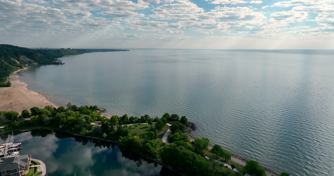 Aerial View of Serene Lake Shoreline with Marina and Sandy Beach — Premium 4K stock footage
