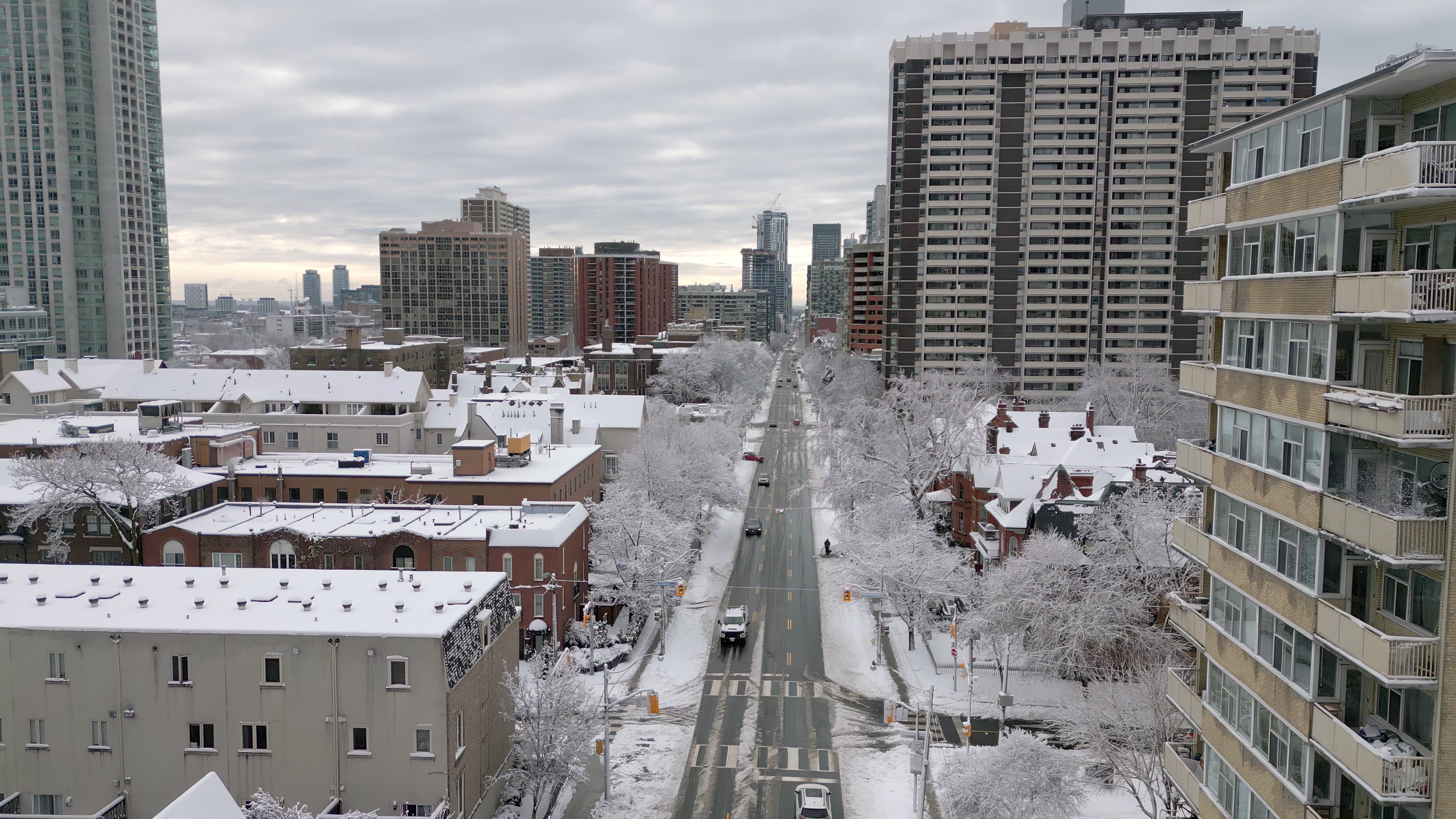 Snow - Covered City Street with Traffic - Aerial in Canada in winter — 4K stock footage