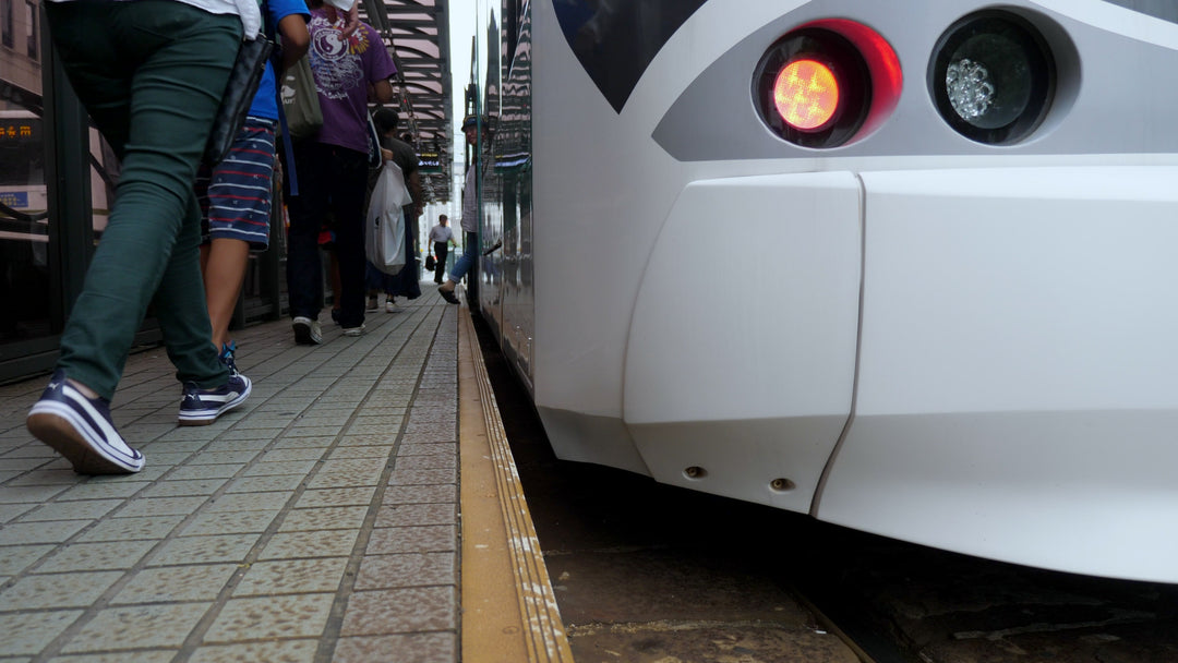Passengers Boarding Modern Tram at Station Platform - Low Angle