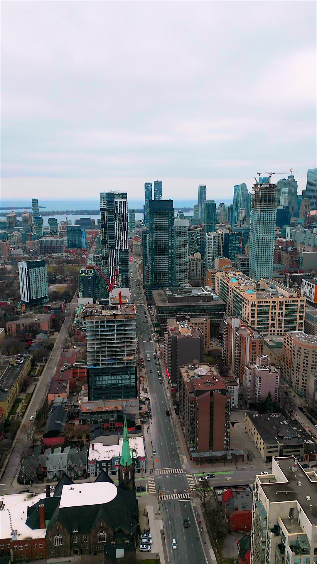 Modern City Skyline with Construction Cranes and Lake - Aerial in Toronto — 4K stock footage
