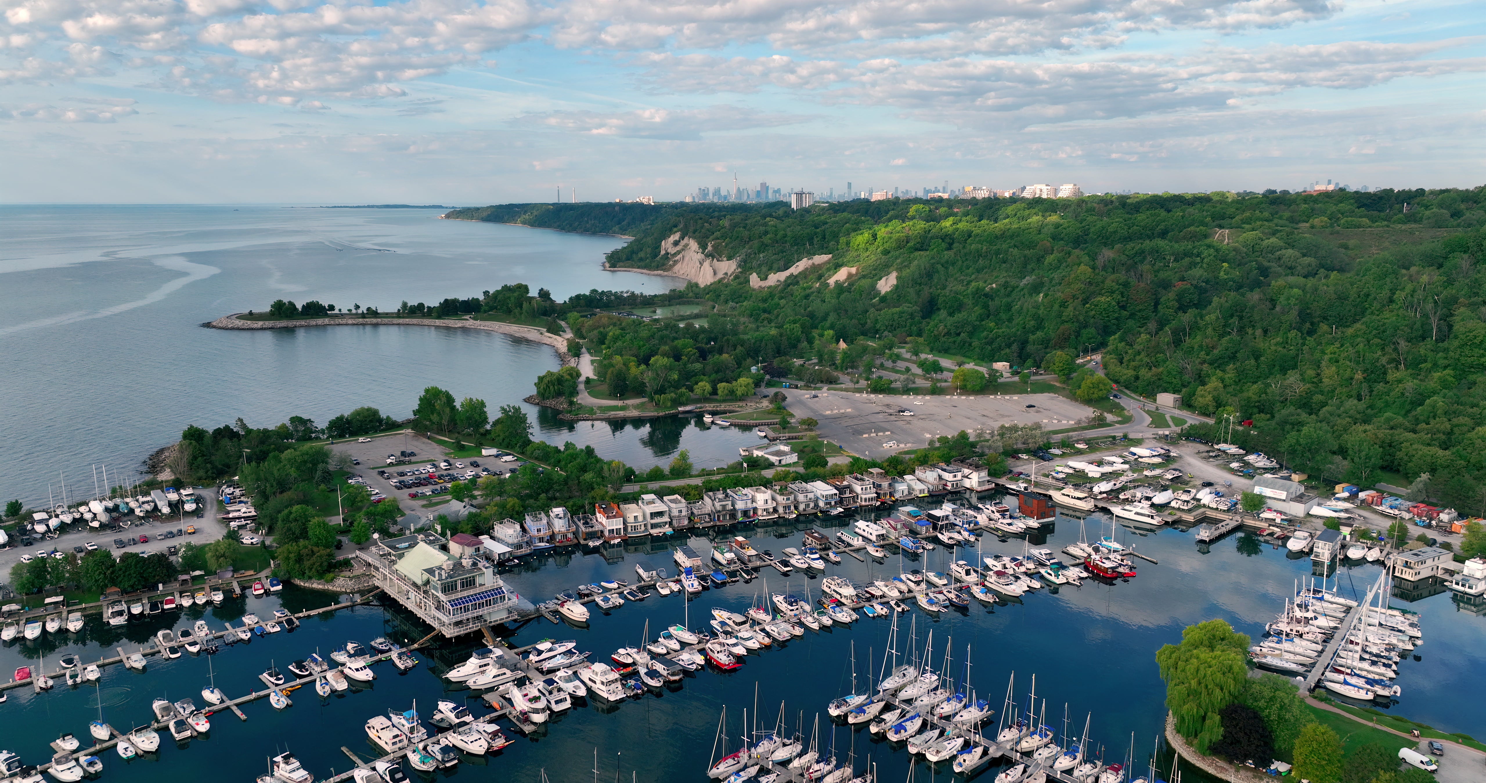 Coastal Marina with City Skyline and Cliffs - Aerial in summer — 4K stock footage