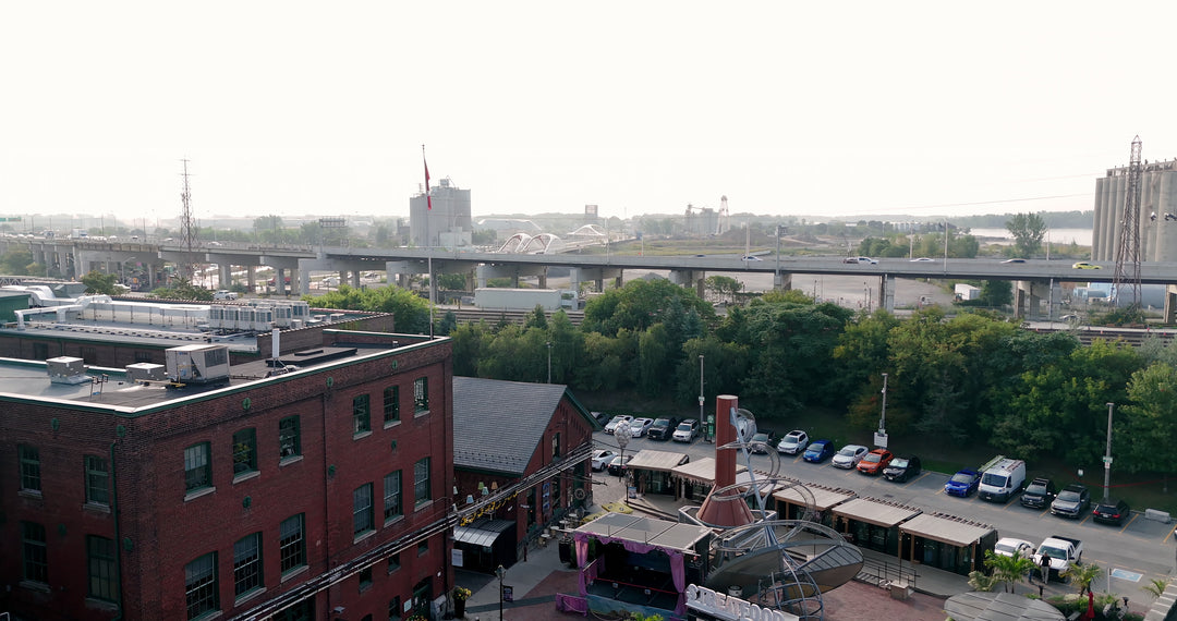 Aerial View of Industrial District with Highway Overpass and Parking Lot — Premium 4K stock footage