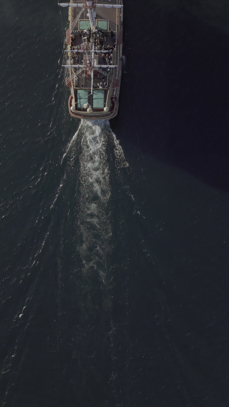 Aerial Top View of Vintage Tourist Ship Sailing on Dark Ocean