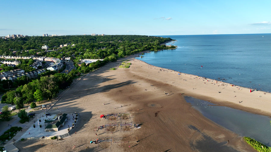 Sandy Beach with Calm Blue Ocean - 4K Aerial