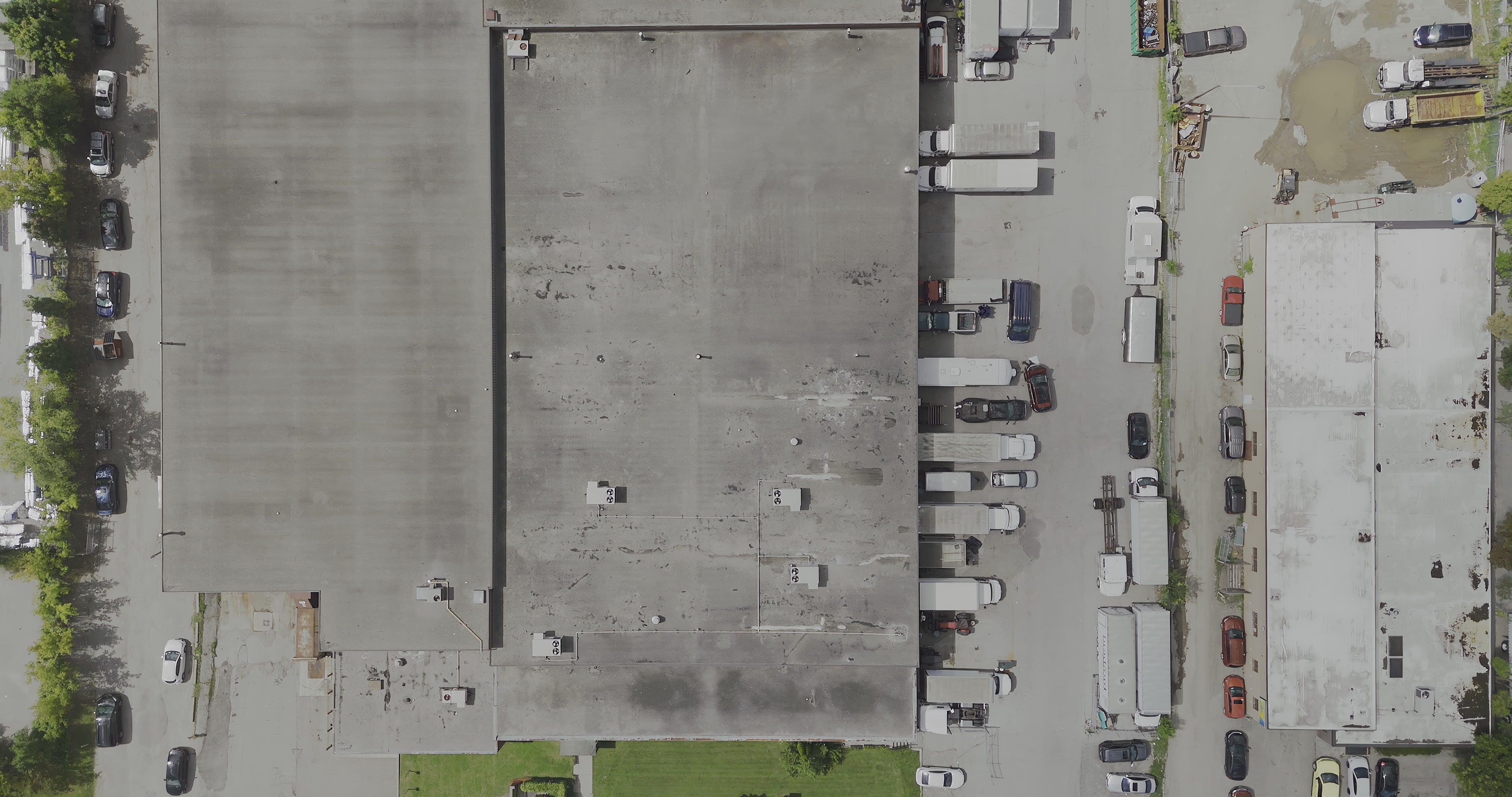 Industrial Warehouse Rooftops and Parking Lot - Top Down — 4K stock footage