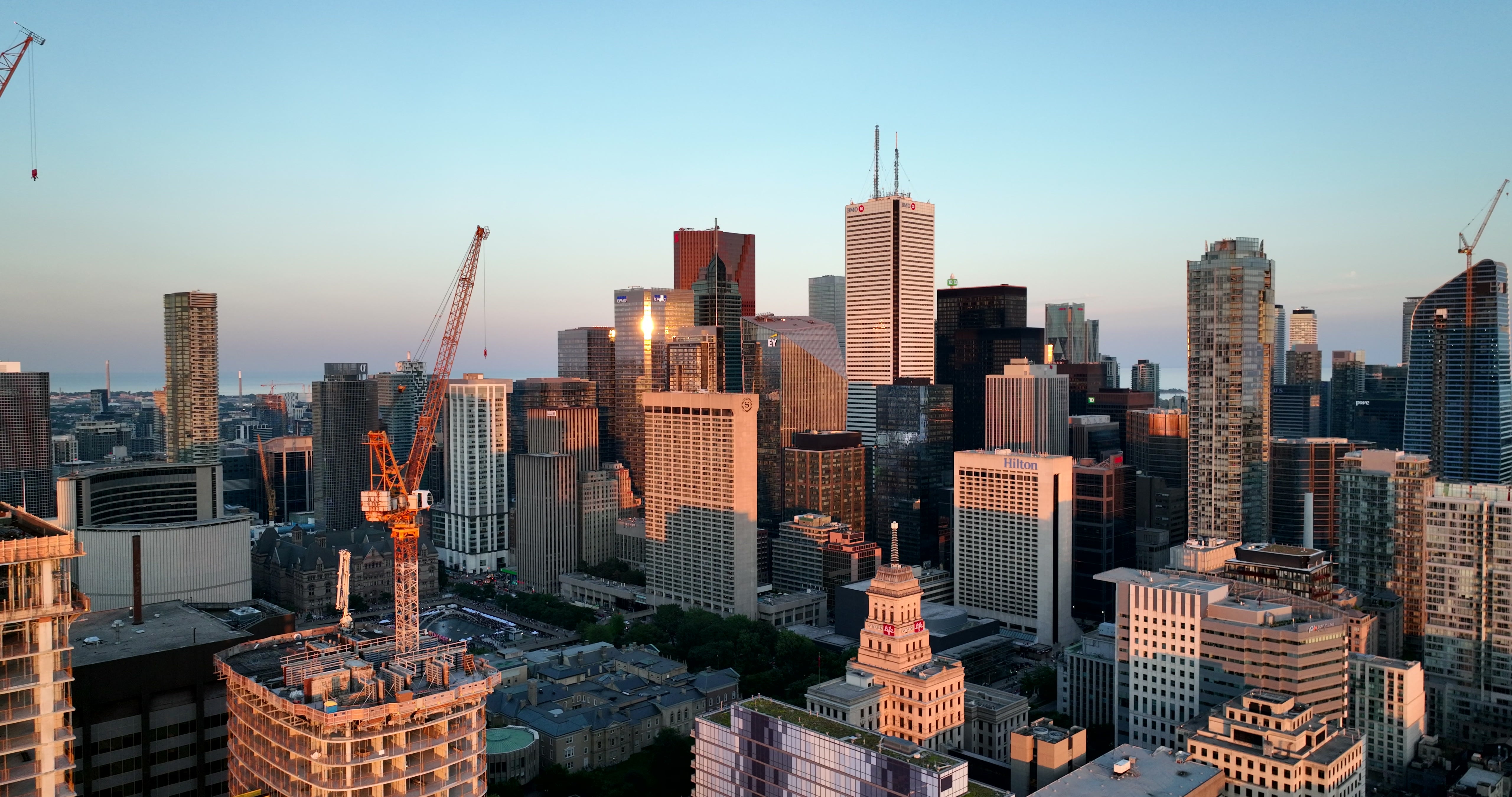 Toronto Downtown Skyline at Golden Hour with Construction Cranes — 4K stock footage