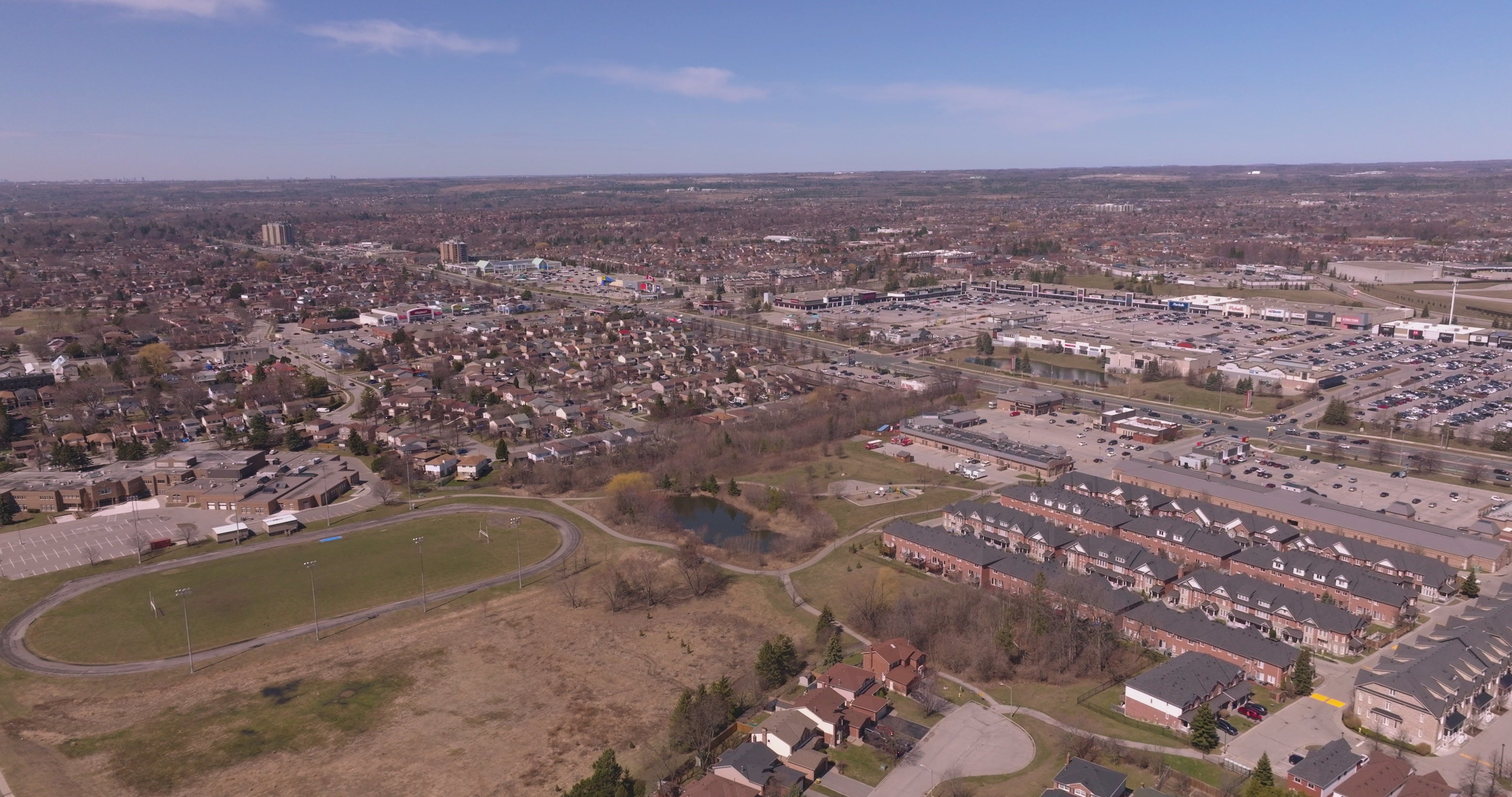 Suburban Shopping Center and Sports Field - Aerial Pan in Toronto — 4K stock footage