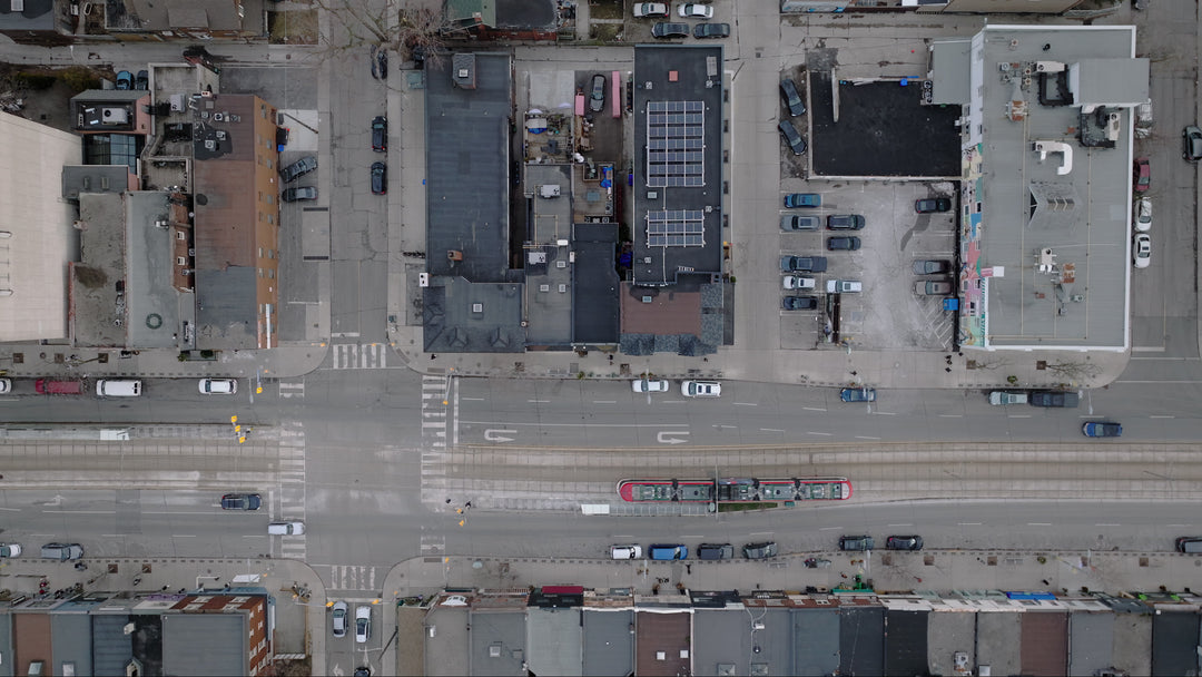 Aerial Top Down View of City Street with Tram and Traffic — Premium 4K stock footage