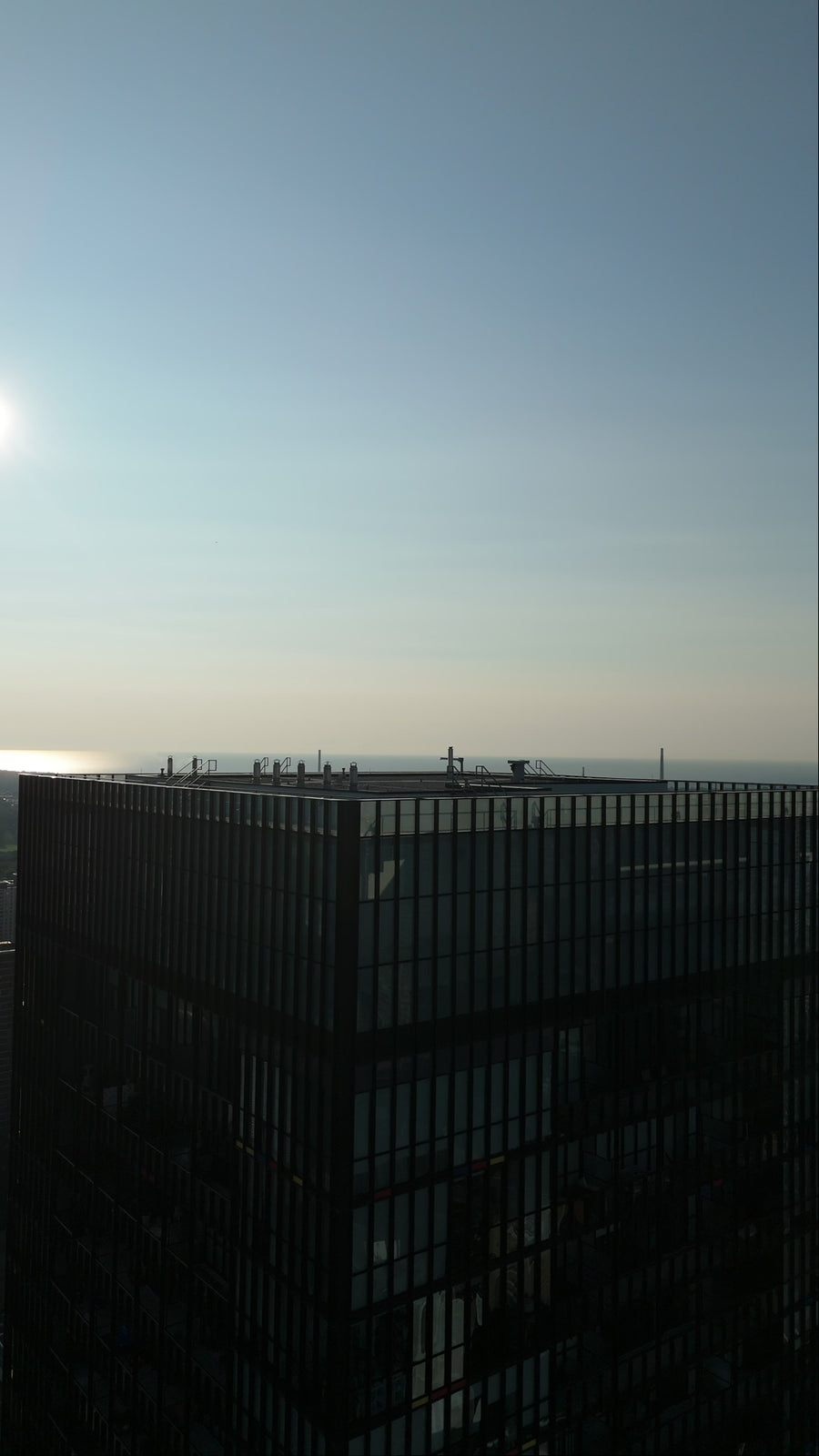 Modern Glass Skyscraper at Sunset with Aerial Descent