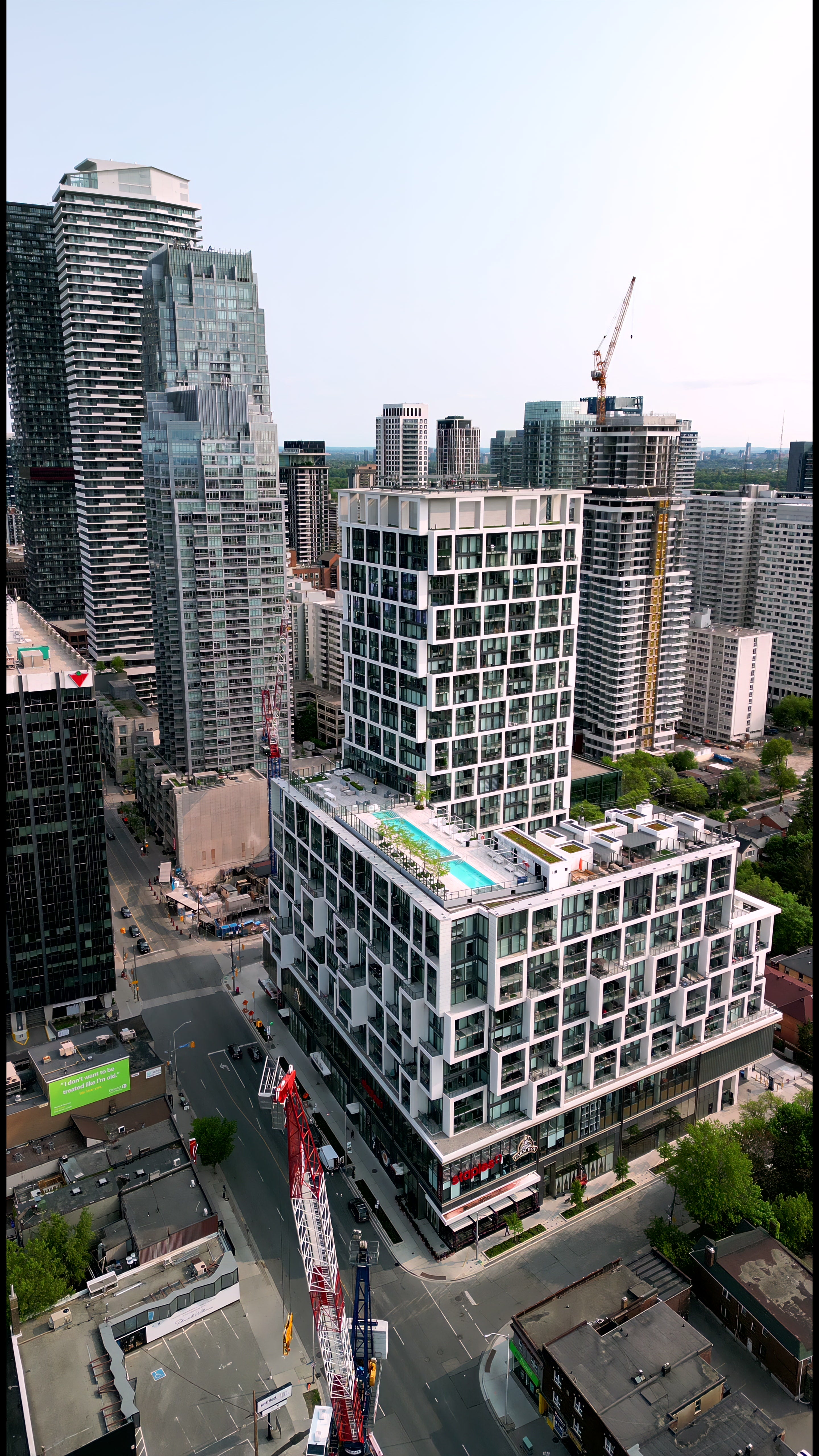 Aerial View Modern Condo Tower with Rooftop Pool in Downtown City in Toronto — 4K stock footage