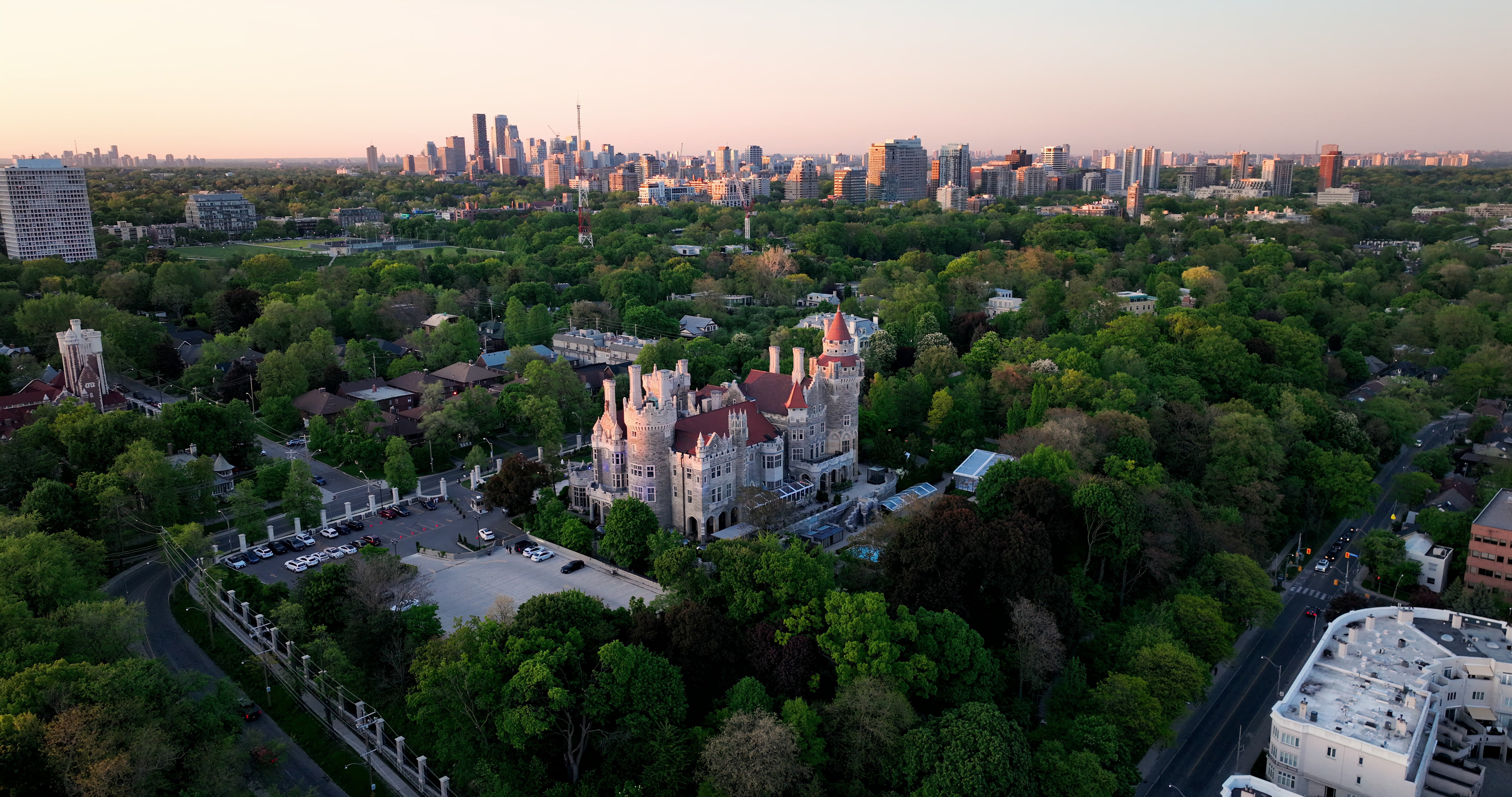 Casa Loma Castle with Toronto Skyline at Sunset - Aerial at golden hour — 4K stock footage