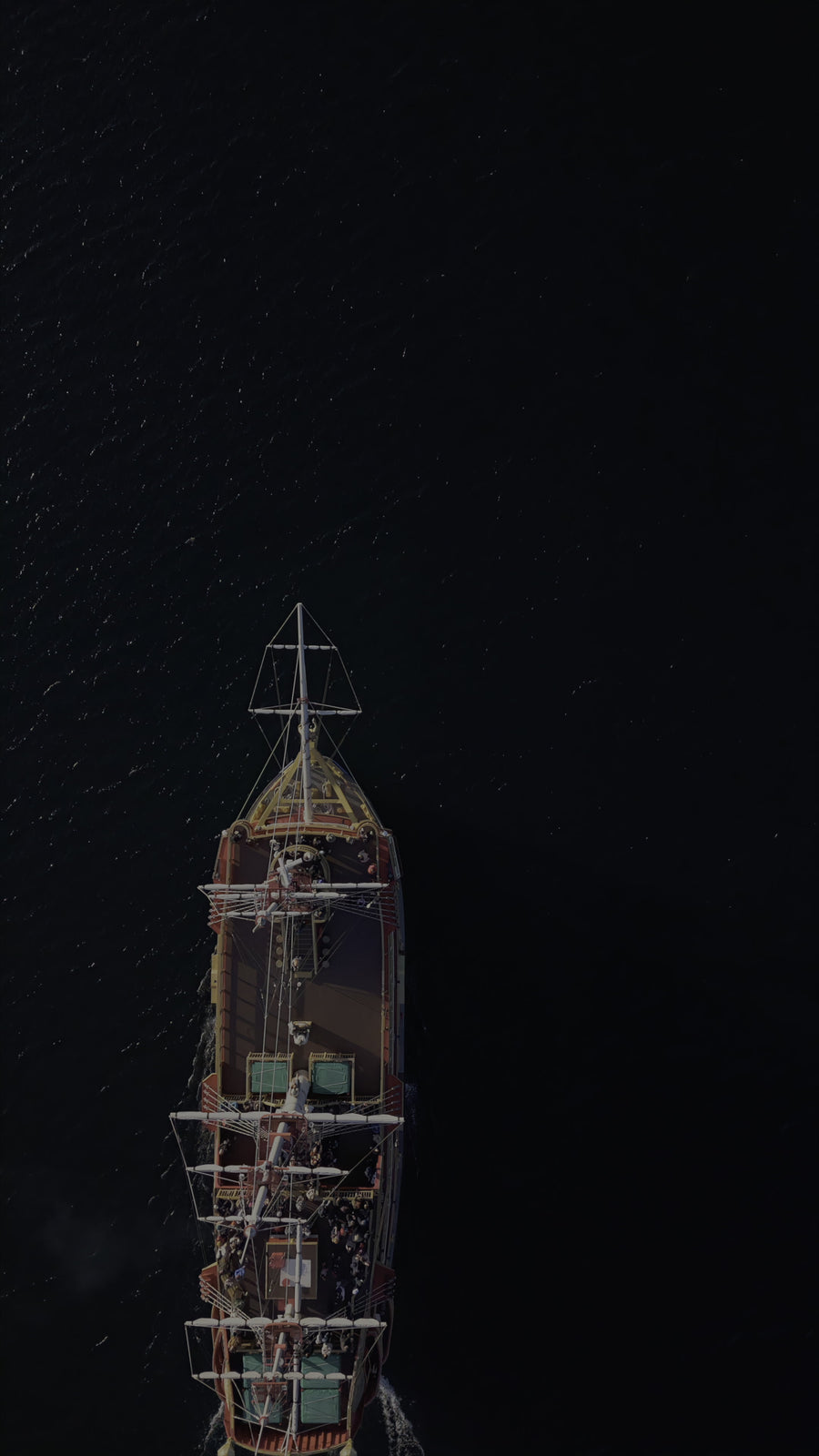 Aerial Top View of Vintage Sailing Ship Cruising on Dark Ocean Waters