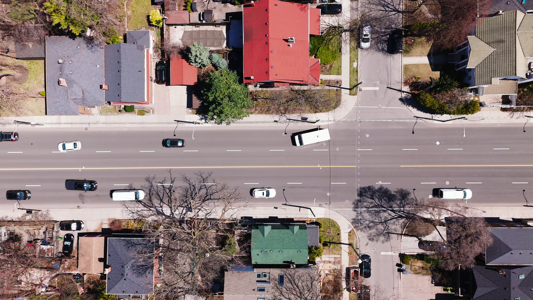 Aerial Top-Down View of Urban Street Traffic and Residential Neighborhood — Premium 4K stock footage
