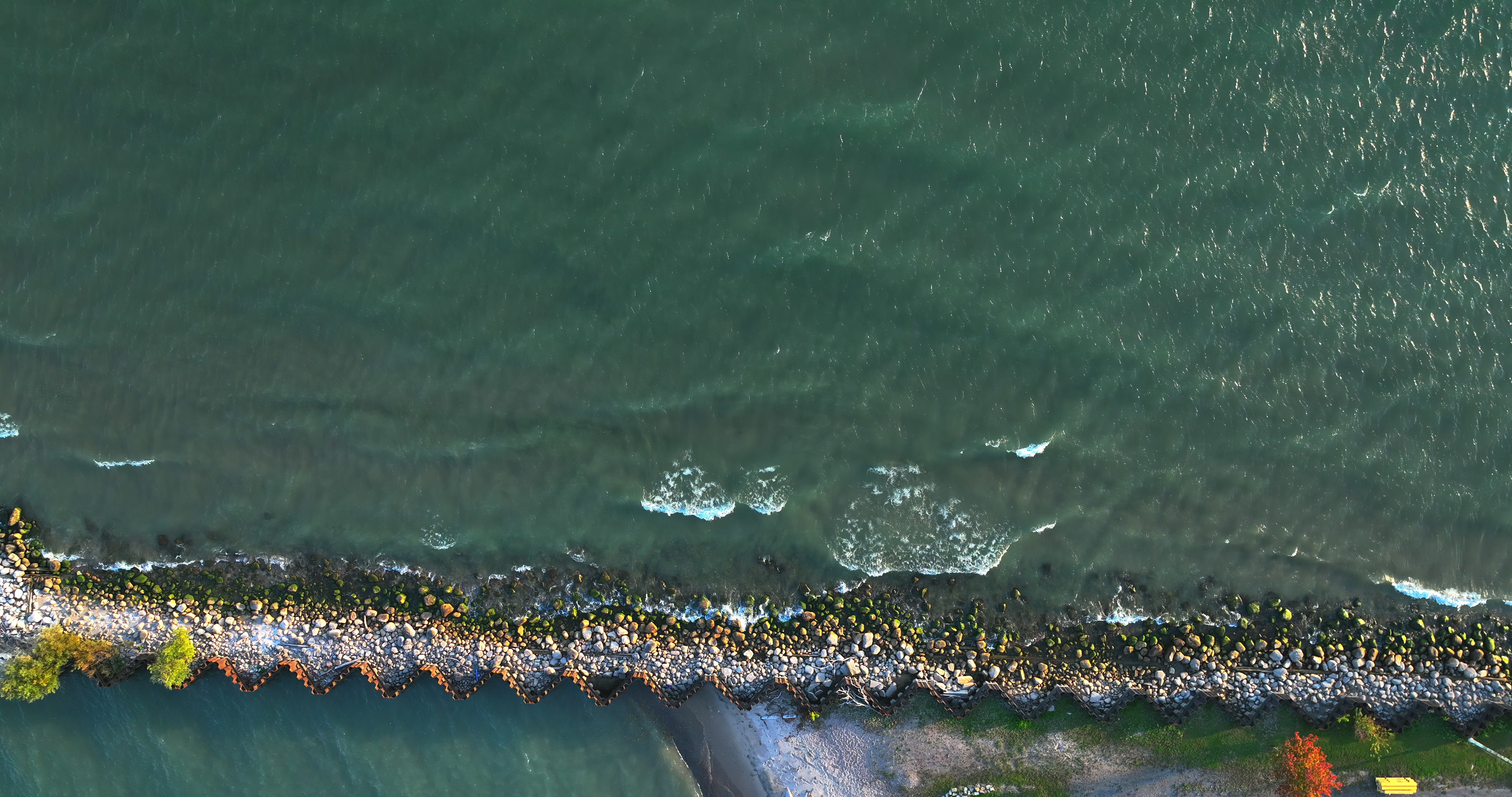 Rocky Seawall Waves Breaking - Aerial — 4K stock footage