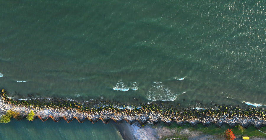 Rocky Seawall Waves Breaking - 5K Aerial