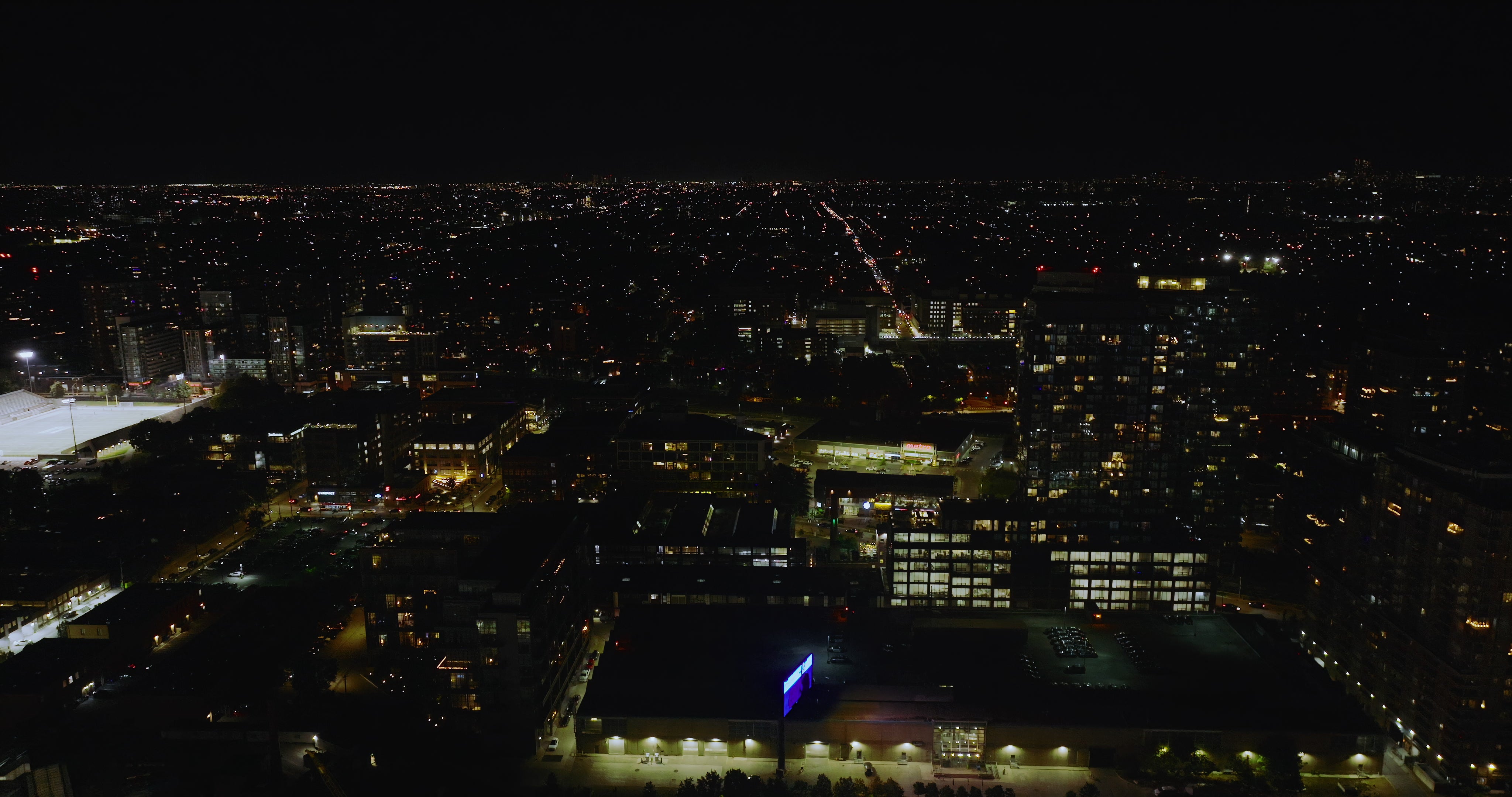 City Skyline at Night with Illuminated Buildings - DCI Aerial — 4K stock footage