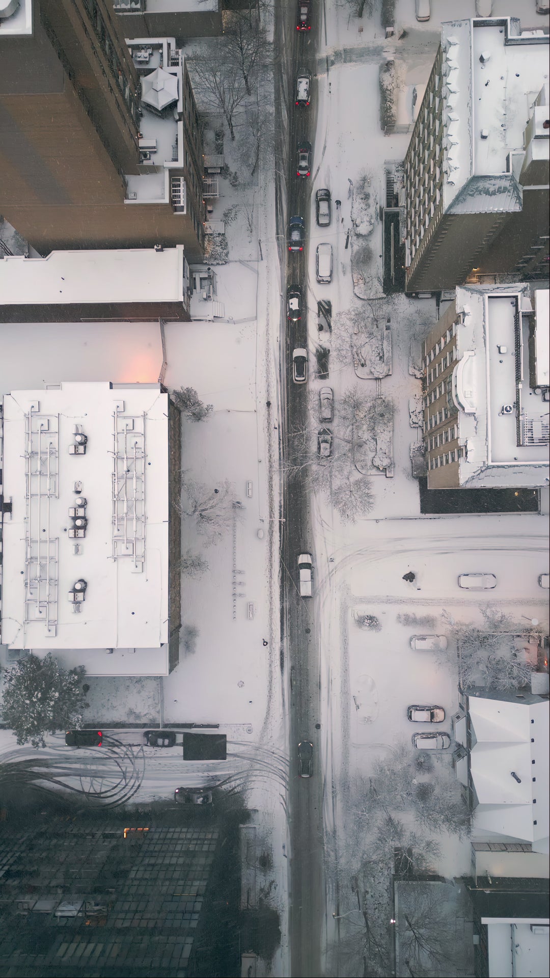 Aerial Top Down View of Snowy City Street with Traffic at Dusk — Premium 4K stock footage