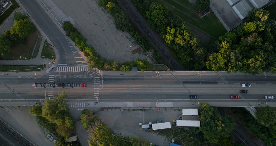 City Street Tram and Traffic at Sunset - Top Down